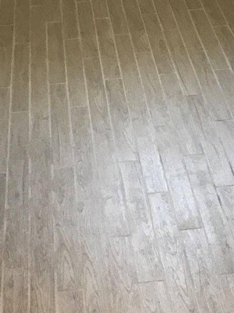 Light gray wood-patterned flooring seen from above