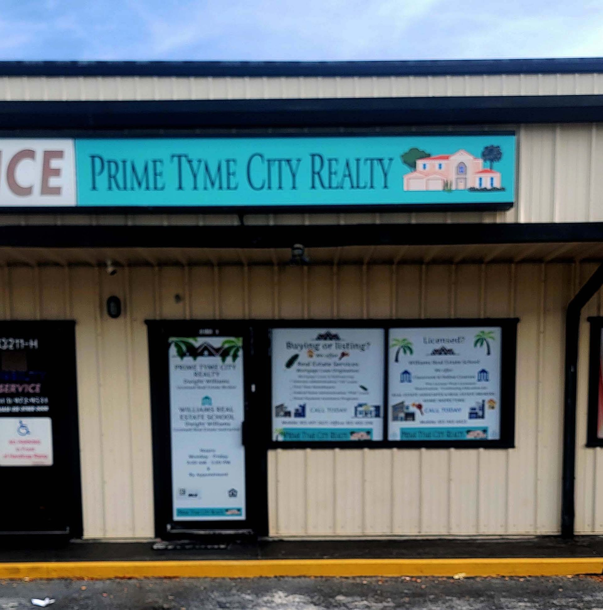 Prime Tyme City Realty storefront with teal signage and windows displaying real estate advertisements.