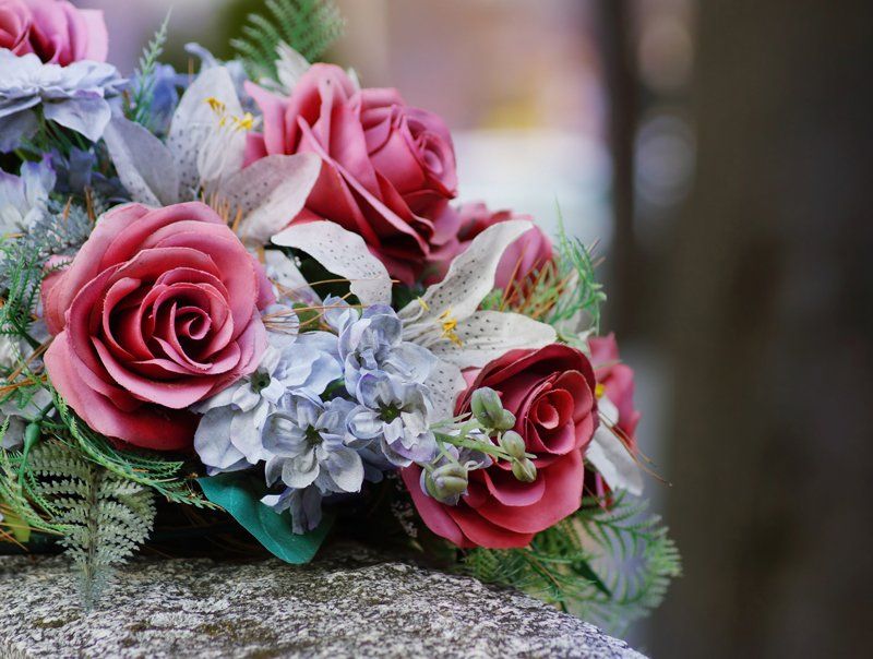 Flowers on a Gravestone — Campbelltown, NSW — Macarthur Lady Funerals Flowers on a Gravestone — Campbelltown, NSW — Macarthur Lady Funerals
