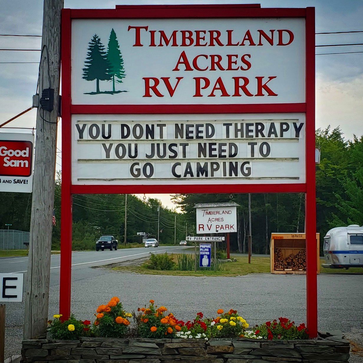 Timberland Acres RV Park sign with message: “You don’t need therapy, you just need to go camping.”