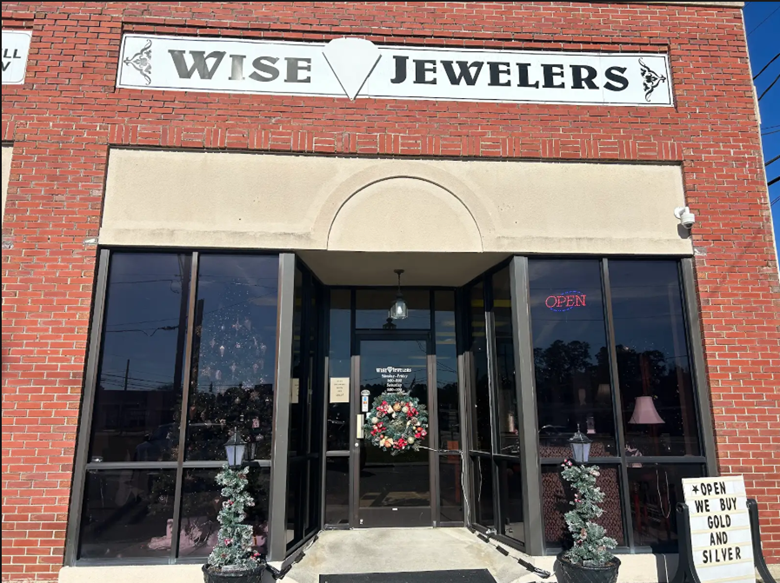 Wise Jewelers storefront with brick facade and large windows. Signage above the door.