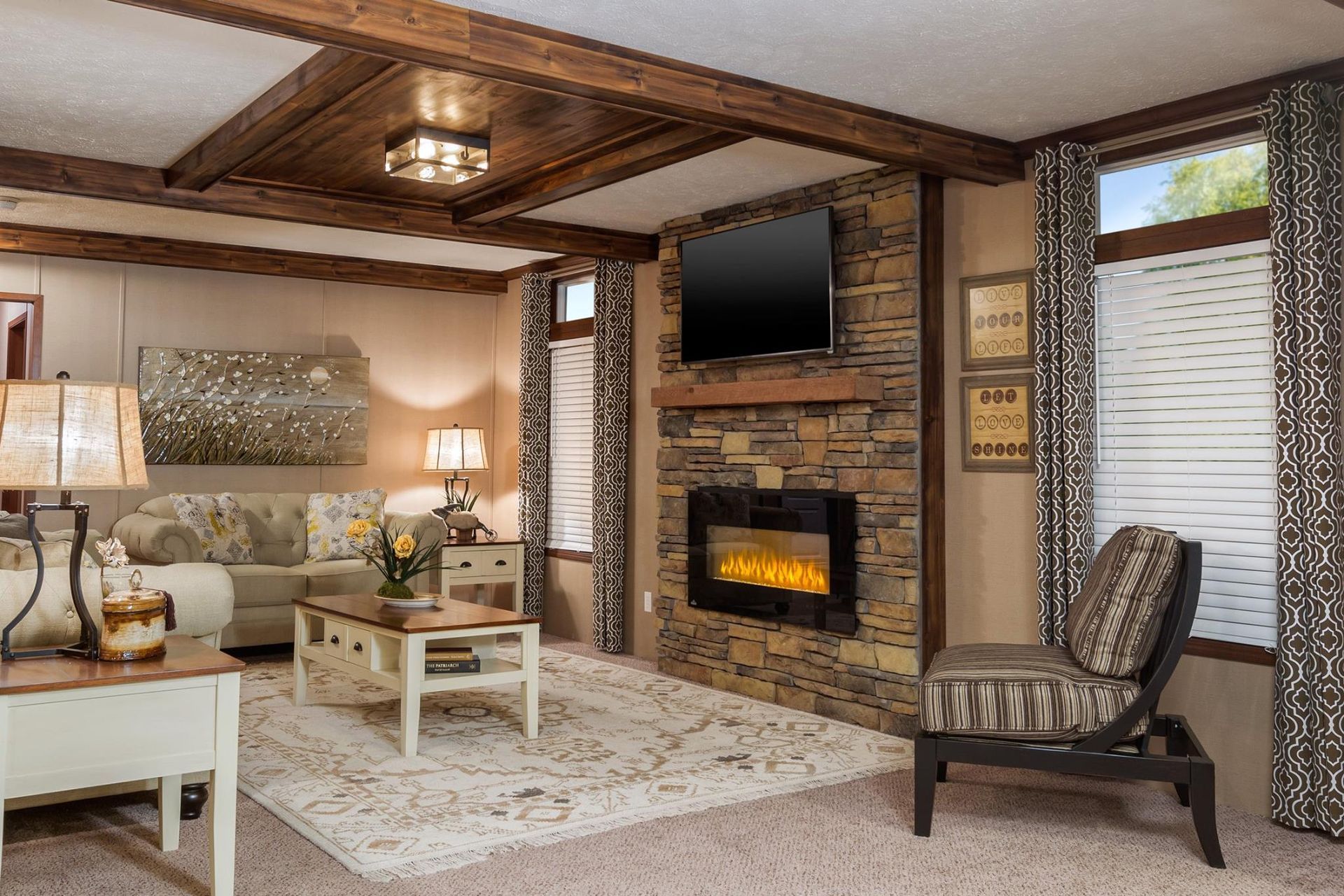 A living room with a fireplace , couch , chair , table and television.