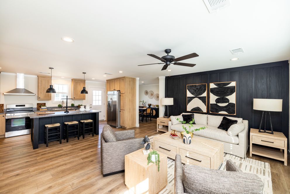 A living room filled with furniture and a ceiling fan.