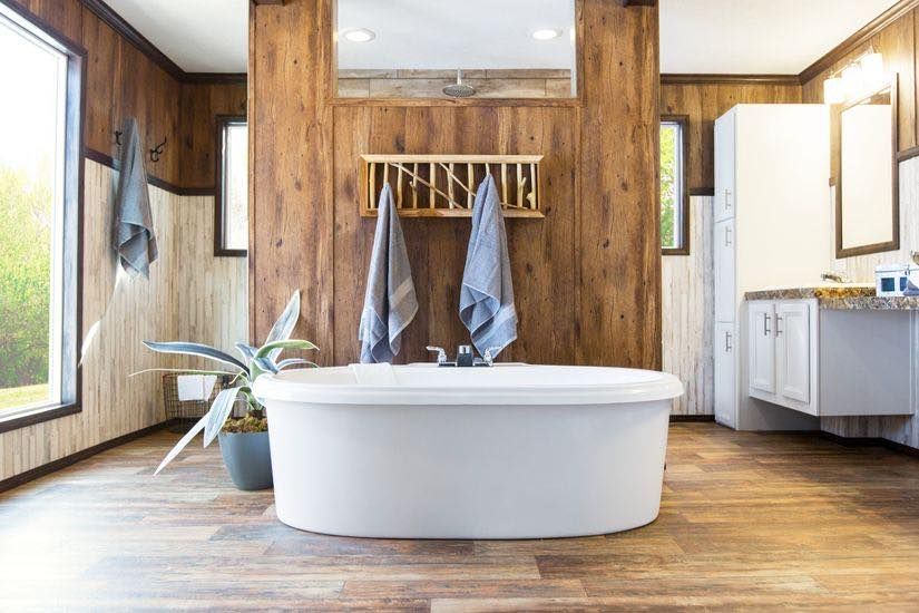 There is a bathtub in the middle of the bathroom.
