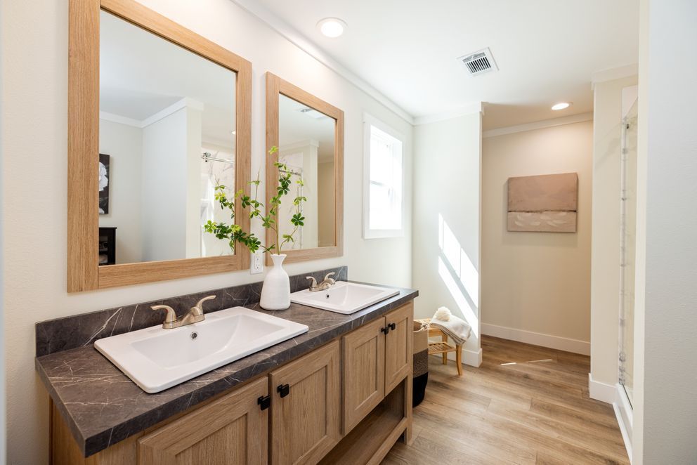 A bathroom with two sinks and two mirrors.