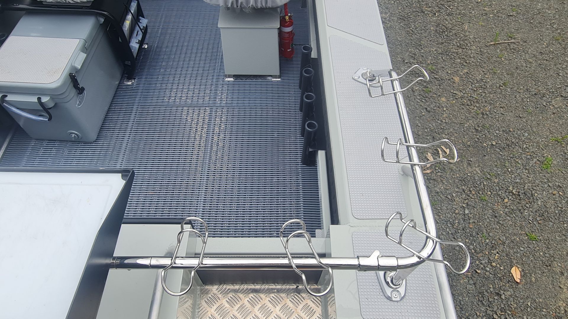 Metal rooftop with HVAC units, gray gravel, and a row of antennas along the edge.