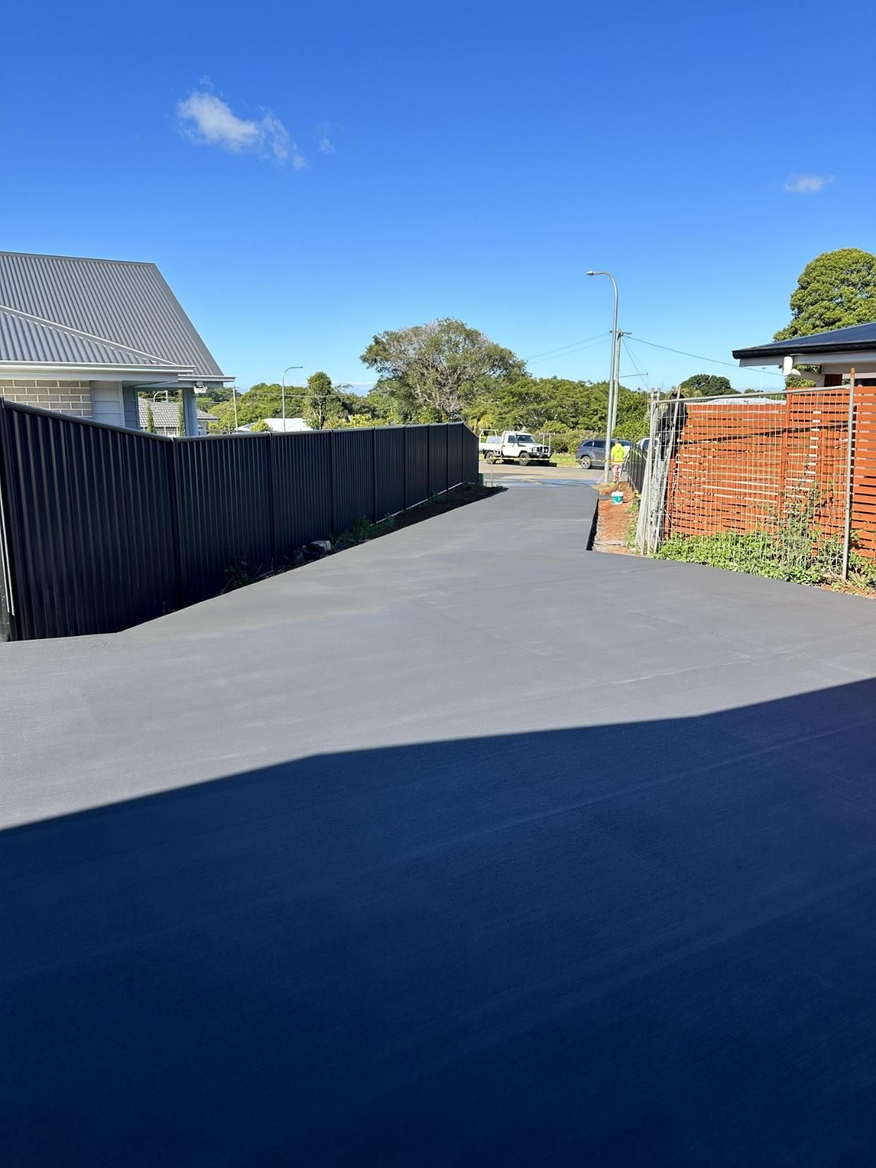 A Fence Along The Side Of A Road Leading To A House — Hinterland Concreting Pty Ltd In Lennox Head, NSW