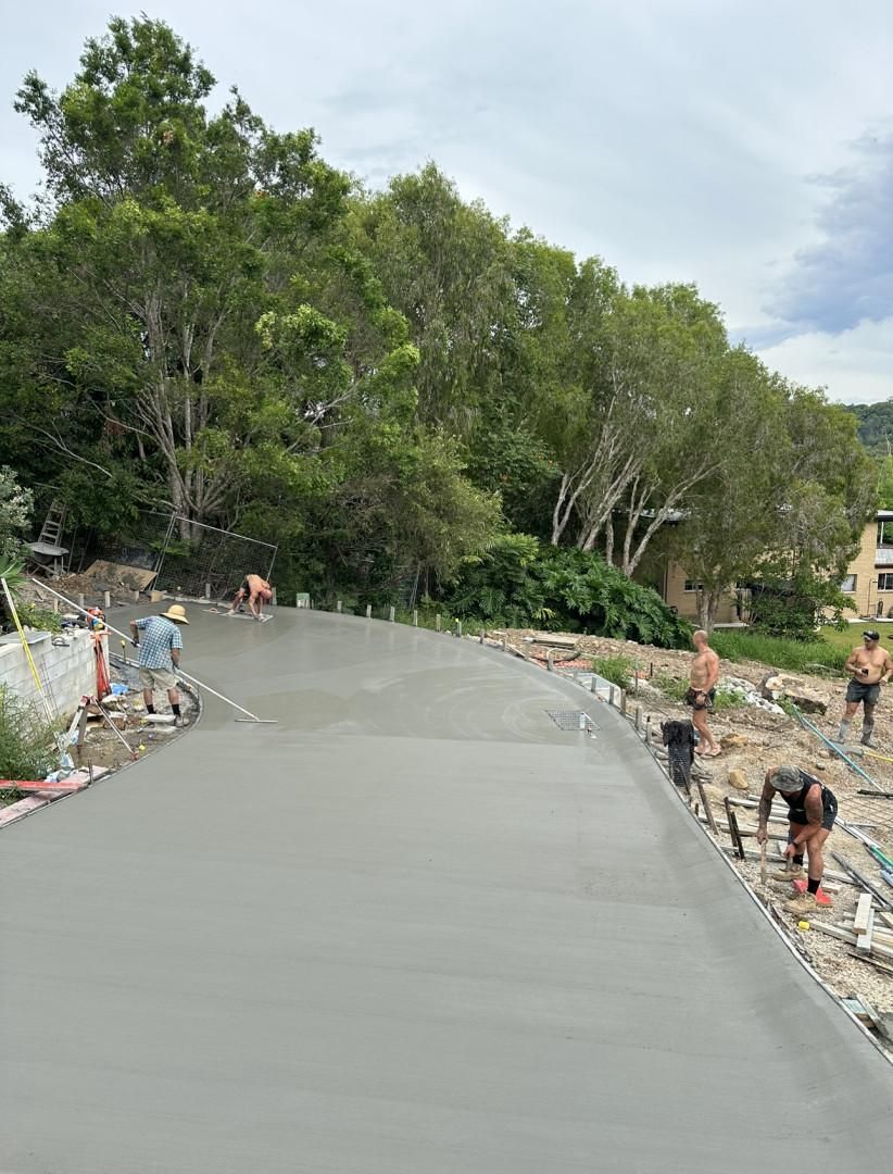 A Group Of People Are Working On A Concrete Road — Hinterland Concreting Pty Ltd In Lennox Head, NSW