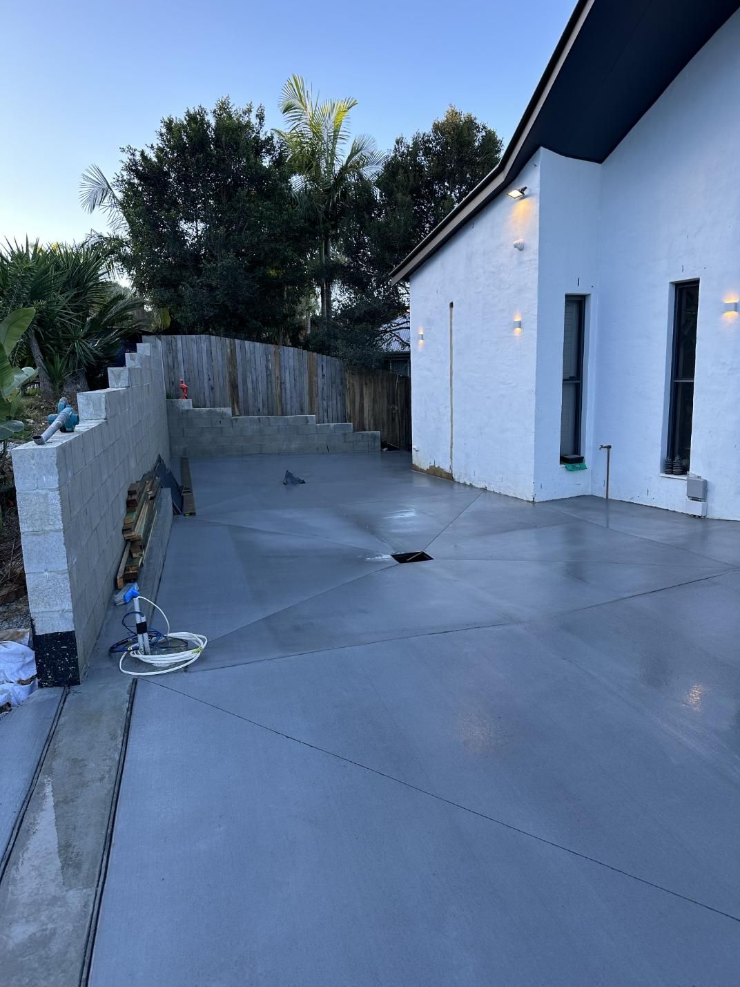 A Man Is Standing On A Set Of Wooden Stairs — Hinterland Concreting Pty Ltd In Lennox Head, NSW