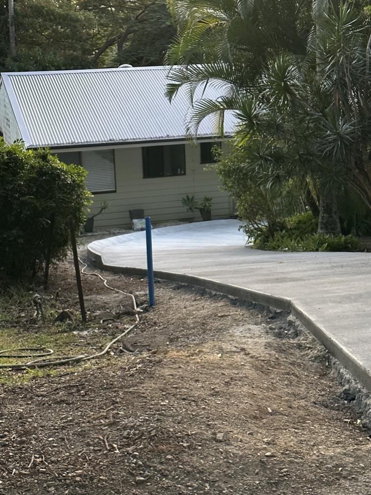 A Concrete Driveway Leading To A House — Hinterland Concreting Pty Ltd In Lennox Head, NSW