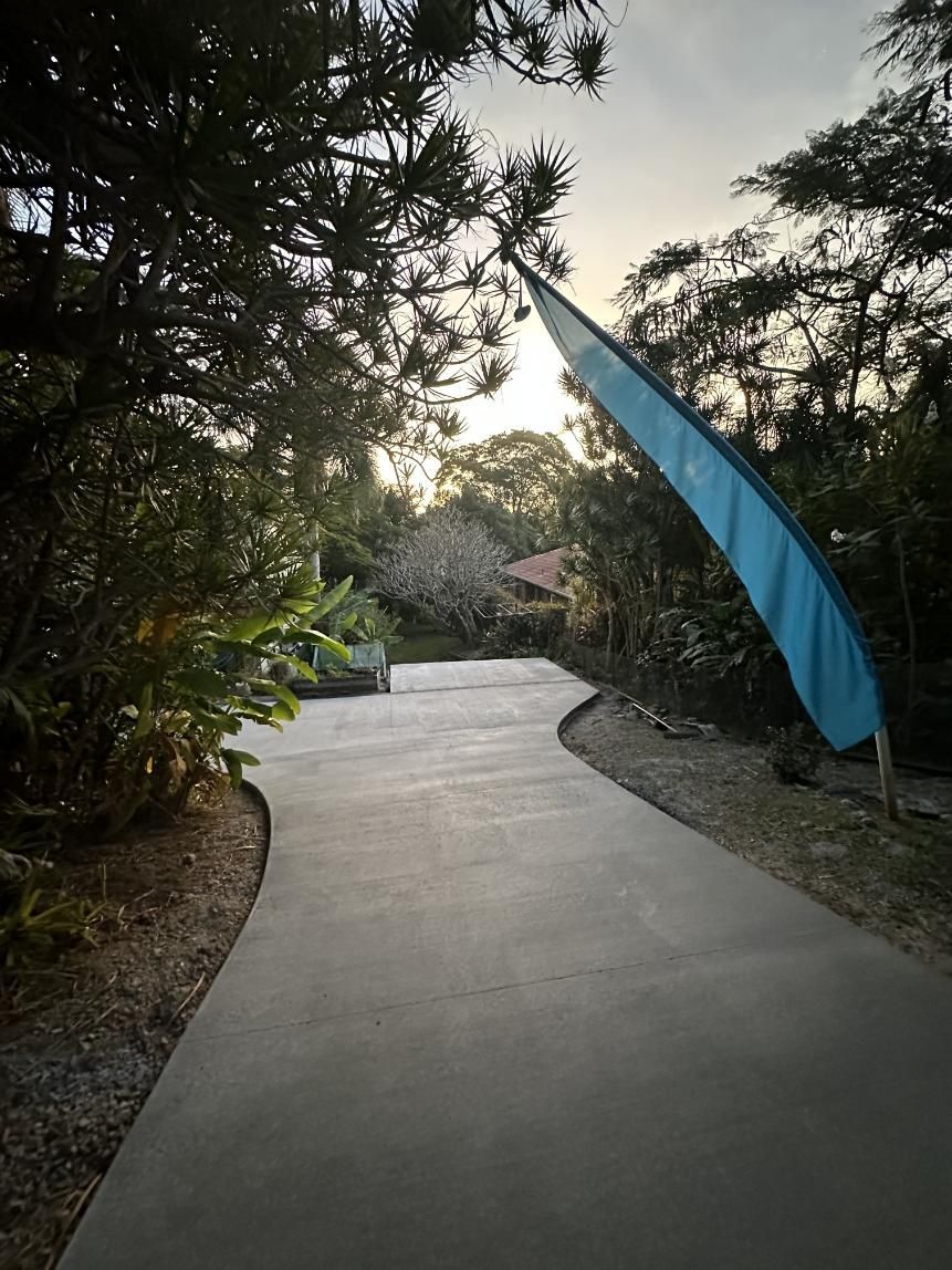 A Blue Flag Is Hanging From A Pole On The Side Of A Road — Hinterland Concreting Pty Ltd In Lennox Head, NSW