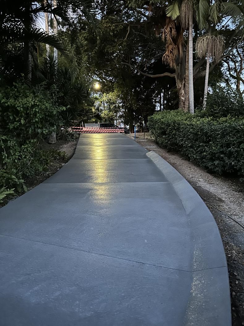 A Concrete Walkway In A Park With Trees On Both Sides — Hinterland Concreting Pty Ltd In Lennox Head, NSW