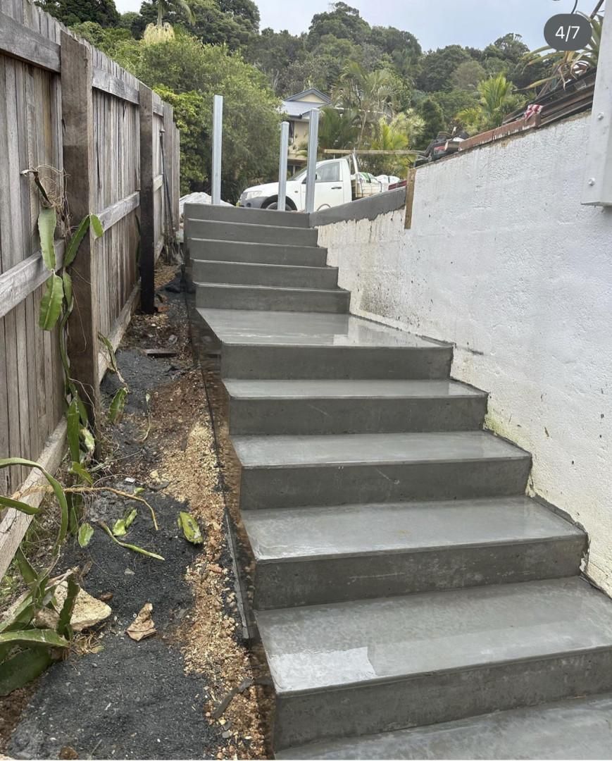 A Set Of Concrete Stairs Leading Up To A Wooden Fence — Hinterland Concreting Pty Ltd In Lennox Head, NSW