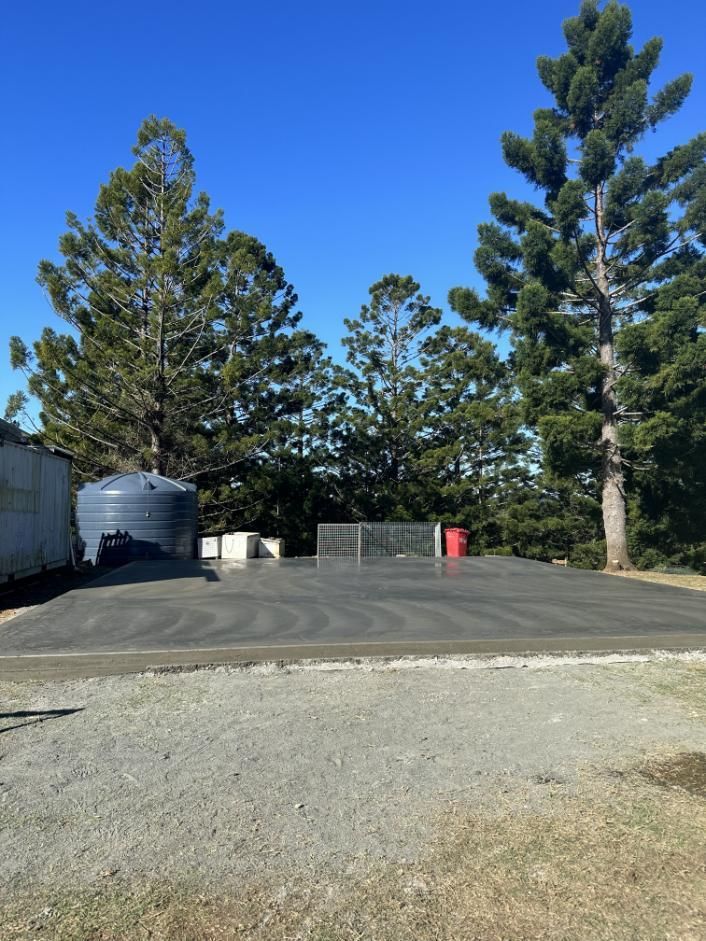 A Concrete Platform With A Water Tank And Trees — Hinterland Concreting Pty Ltd In Lennox Head, NSW