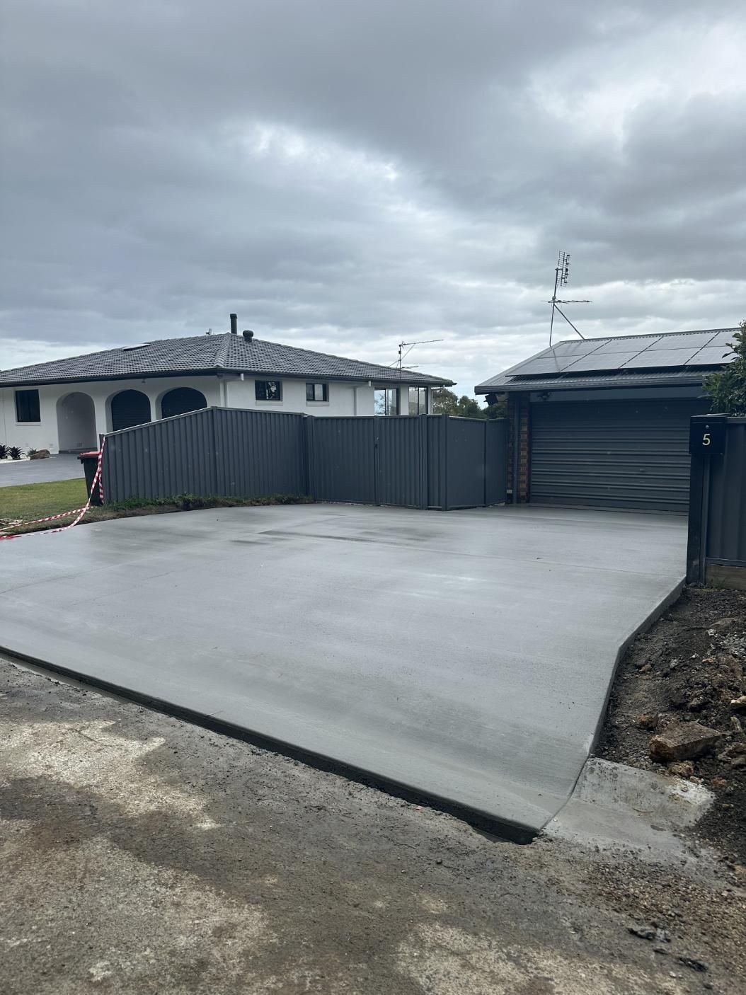 A Concrete Driveway Is Being Built In Front Of A House — Hinterland Concreting Pty Ltd In Lennox Head, NSW