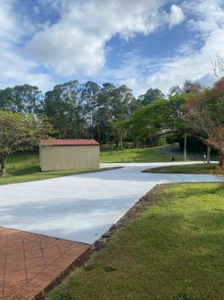 A Concrete Driveway With A Shed In The Background — Hinterland Concreting Pty Ltd In Lismore, NSW