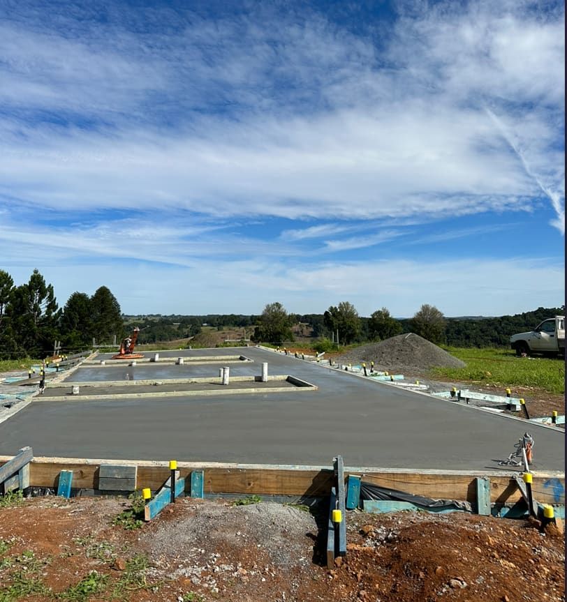 A Concrete Foundation Is Being Built In A Field — Hinterland Concreting Pty Ltd In Lennox Head, NSW