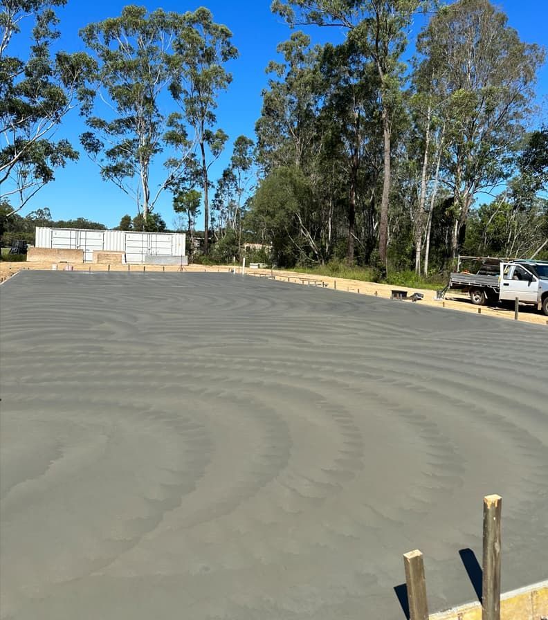 Concrete Driveway Surrounded By Trees — Hinterland Concreting Pty Ltd In Lennox Head, NSW