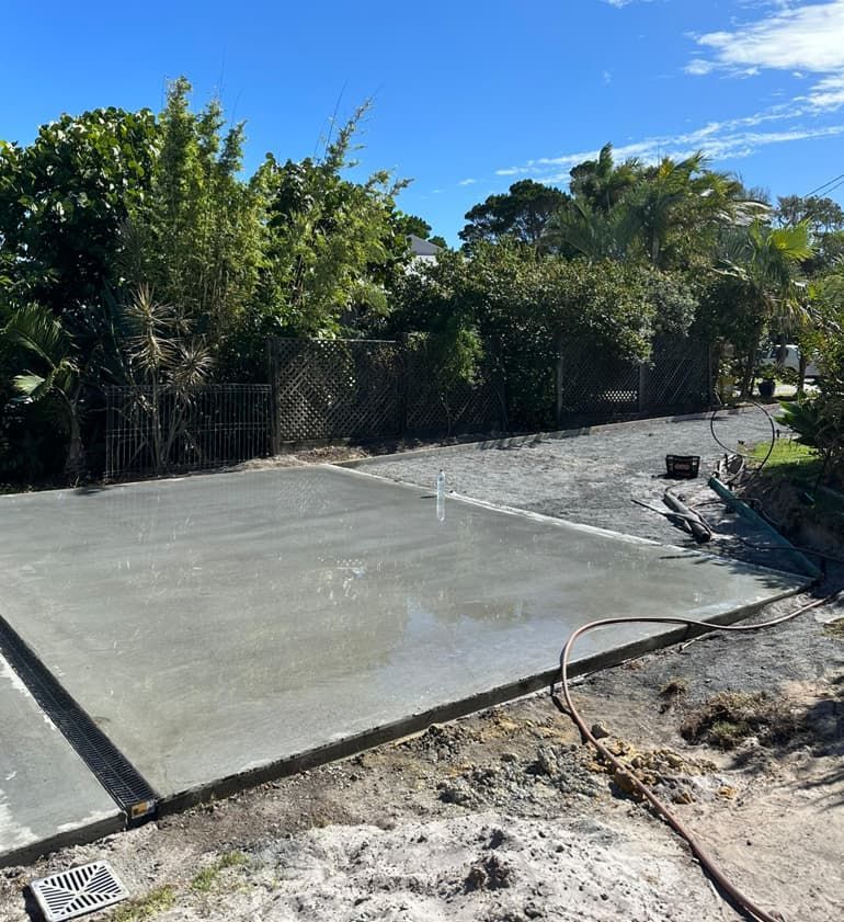 A Concrete Driveway Is Being Built In A Yard With Trees In The Background — Hinterland Concreting Pty Ltd In Lennox Head, NSW