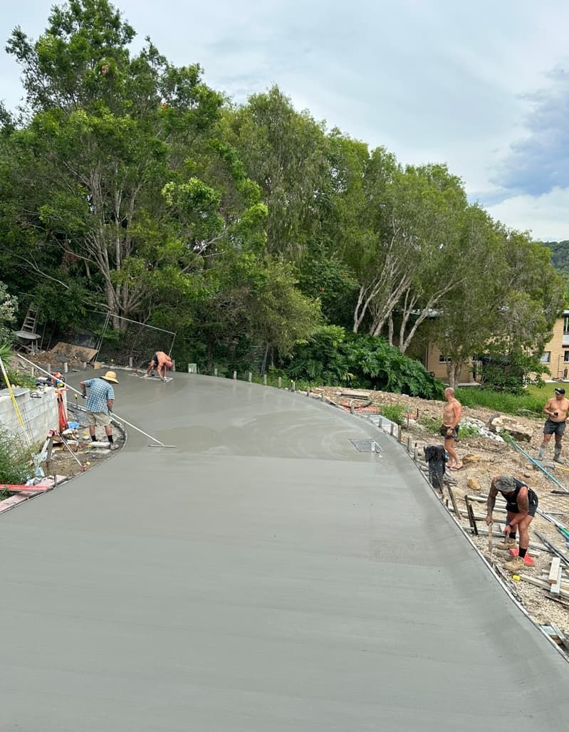 A Group Of People Are Working On A Concrete Road — Hinterland Concreting Pty Ltd In Lennox Head, NSW