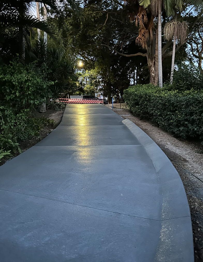 A Concrete Walkway In A Park With Trees On Both Sides — Hinterland Concreting Pty Ltd In Lennox Head, NSW