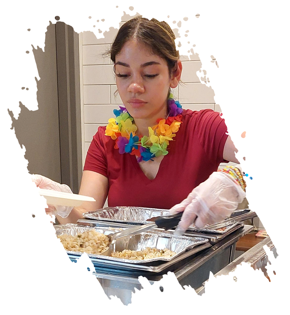 Woman with lei, gloves, preparing food in containers.