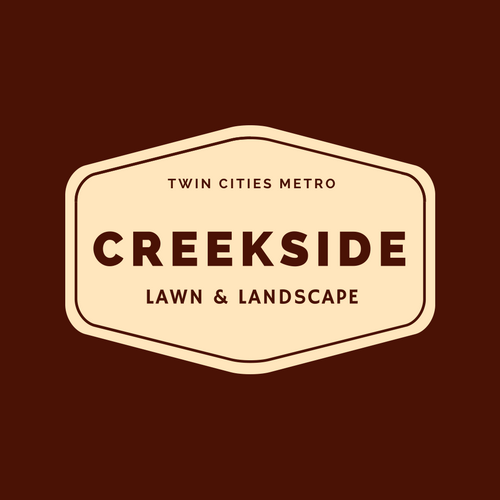 A logo for creekside lawn and landscape on a brown background.