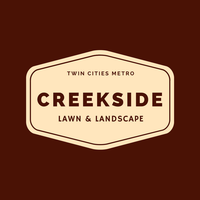 A logo for creekside lawn and landscape on a brown background.