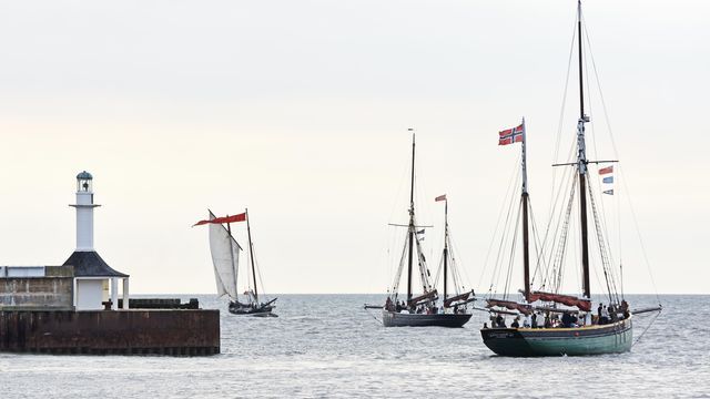 Boats sailing through the mouth of the harbour in Lowestoft