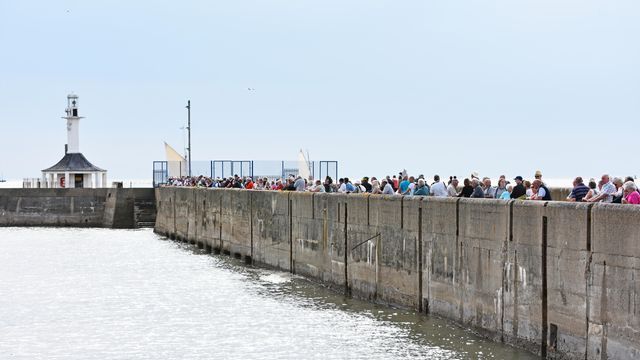 Thousands of people line the harbour wall for the historic festival