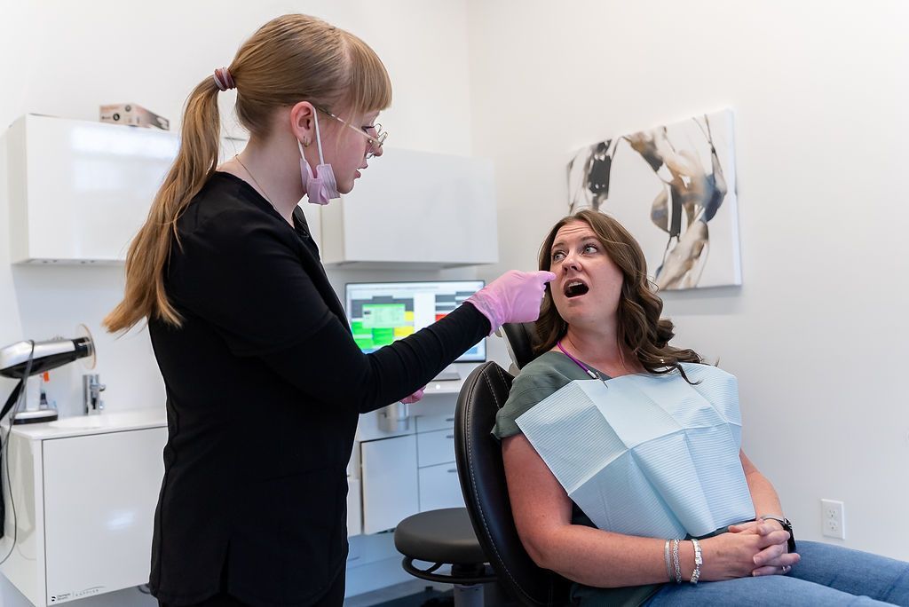 Dentist examining a patient in a dental chair
