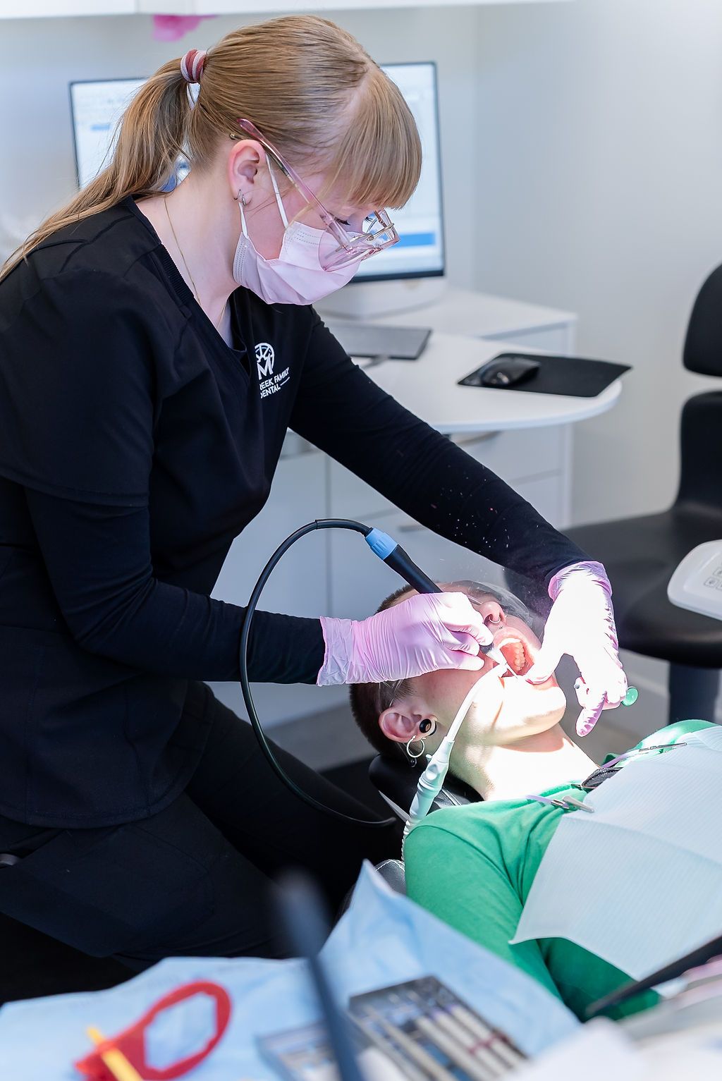 Dental professional examining a patient's teeth during a comprehensive oral health examDental professional examining a patient's teeth during a comprehensive oral health exam