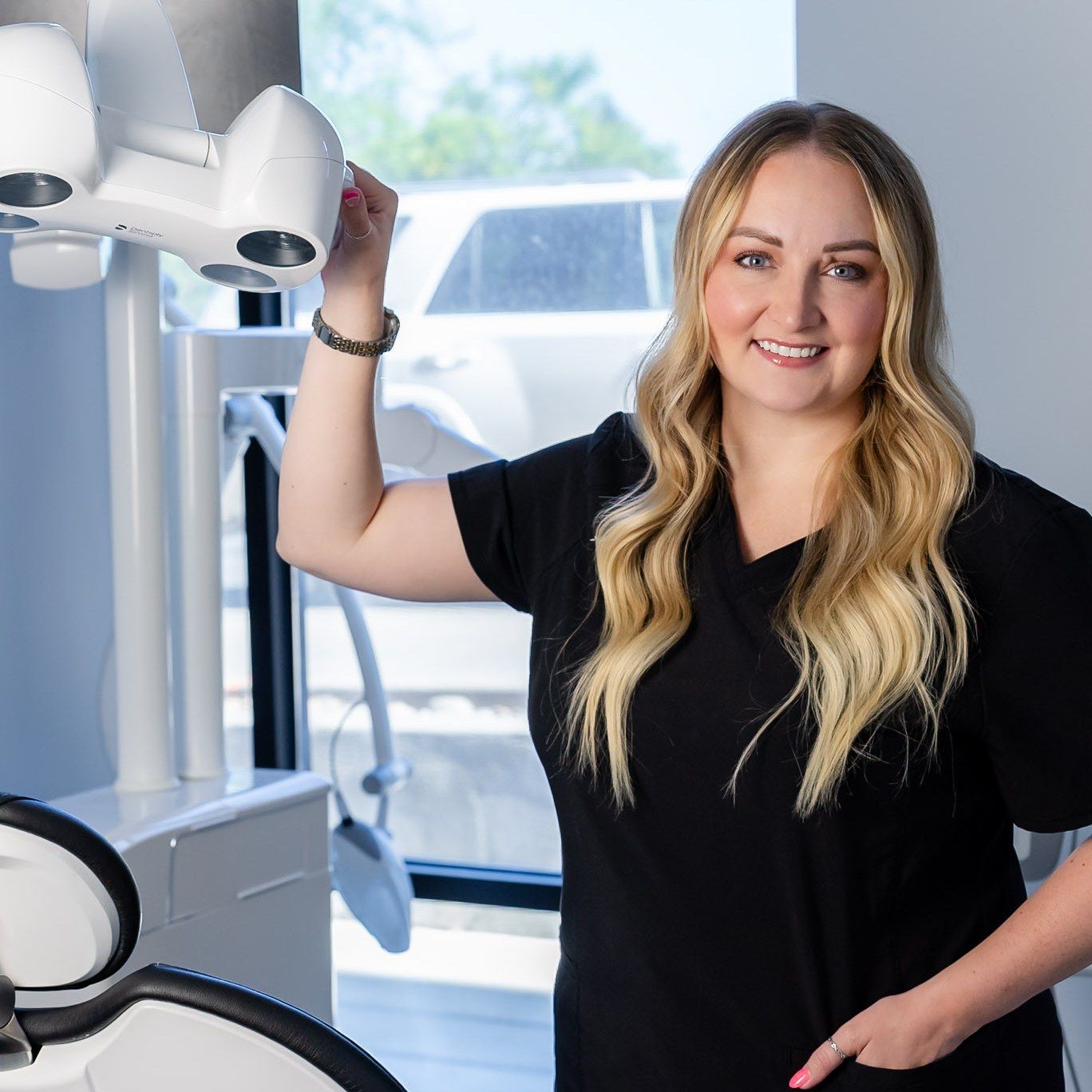 Millcreek Family Dental team member waving hello in a Bountiful treatment room