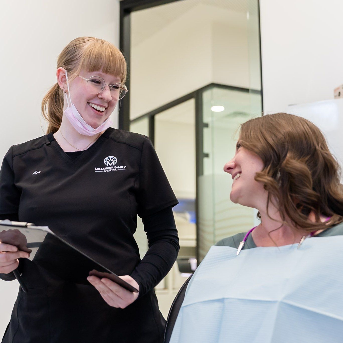 Millcreek Family Dental team member smiling with a patient in Bountiful, UT
