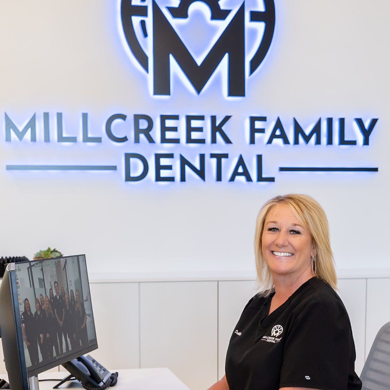 Smiling front desk team member at Millcreek Family Dental in Bountiful, UT