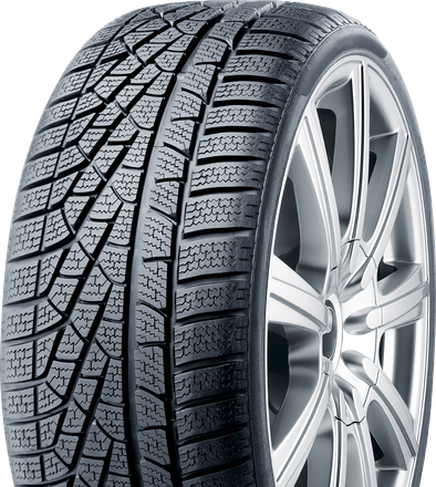 Winter tire with deep tread on a silver alloy wheel, designed for snowy conditions.