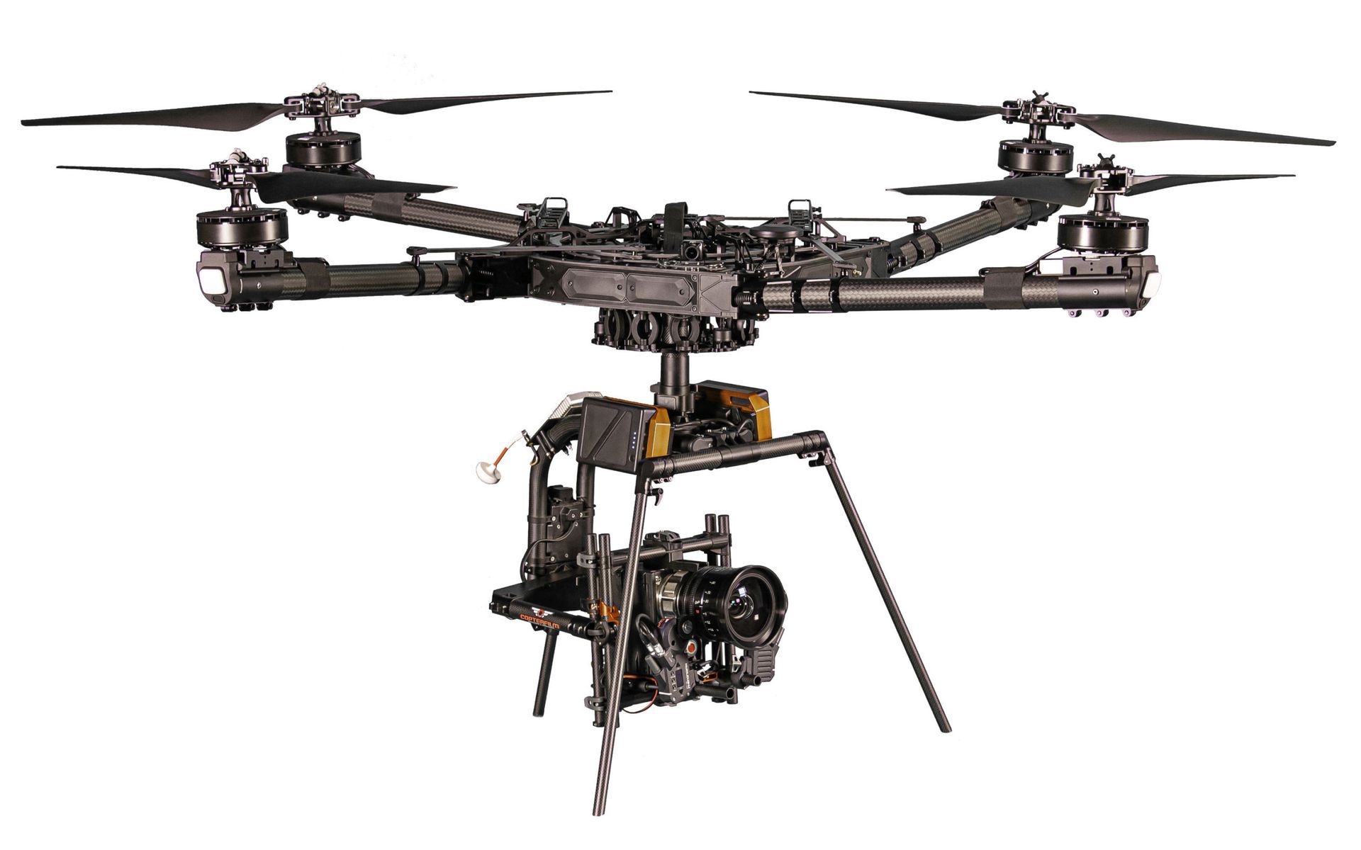 Black drone with attached camera, suspended in air.