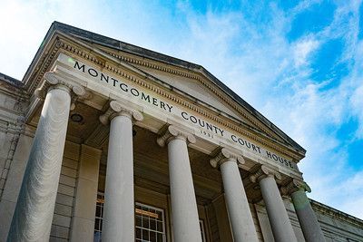 Montgomery County Courthouse with pillars and blue sky.