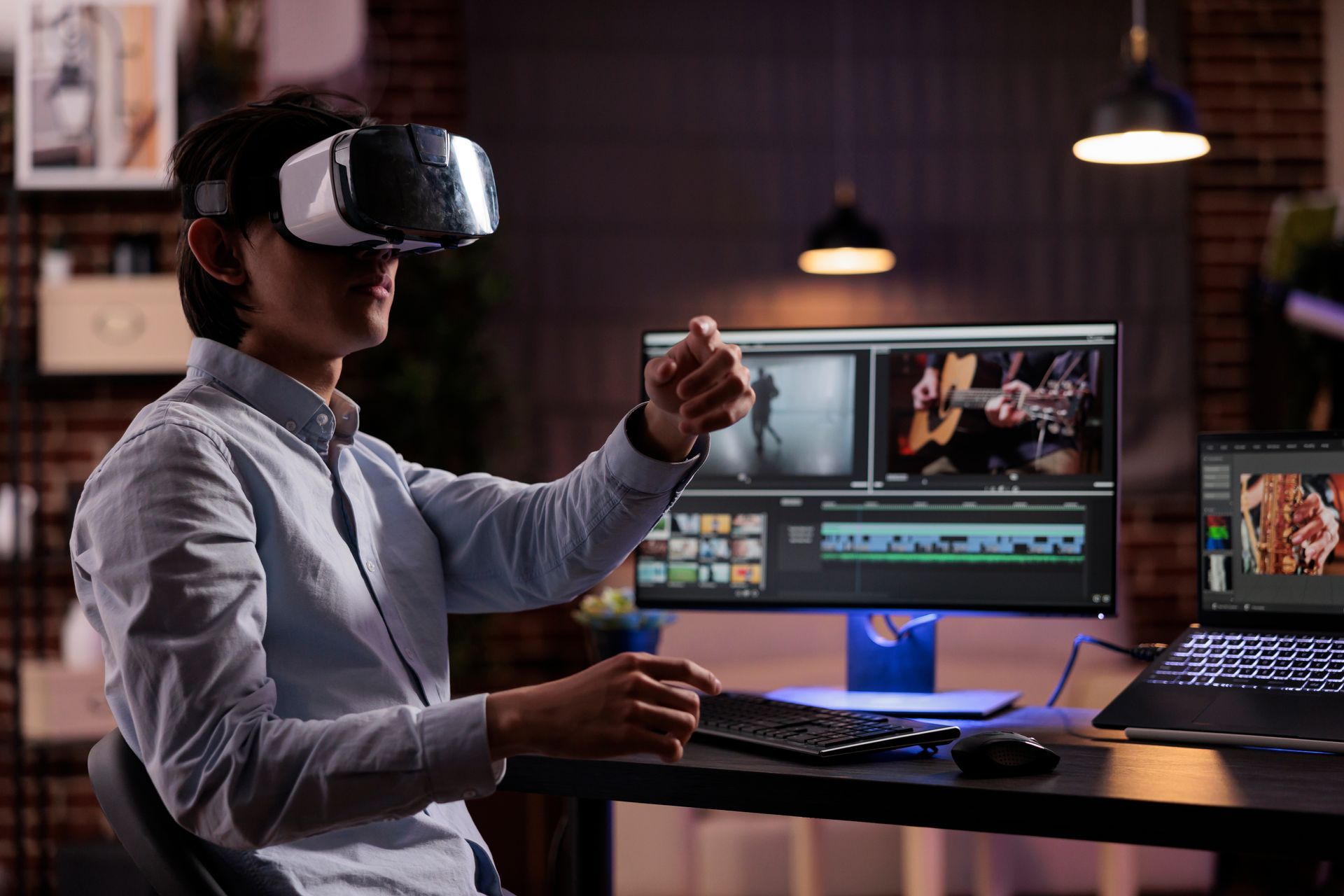 A man wearing a virtual reality headset is sitting in front of a computer.