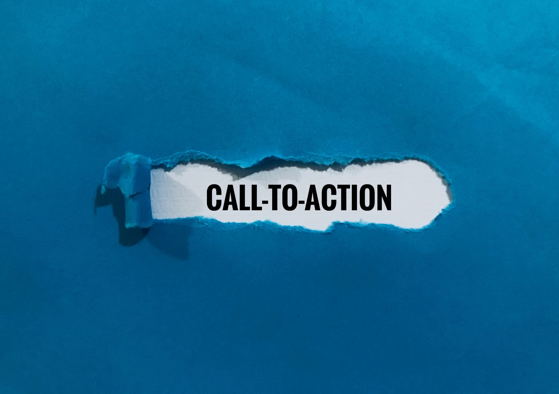 A piece of torn paper with the words `` call to action '' written on it.