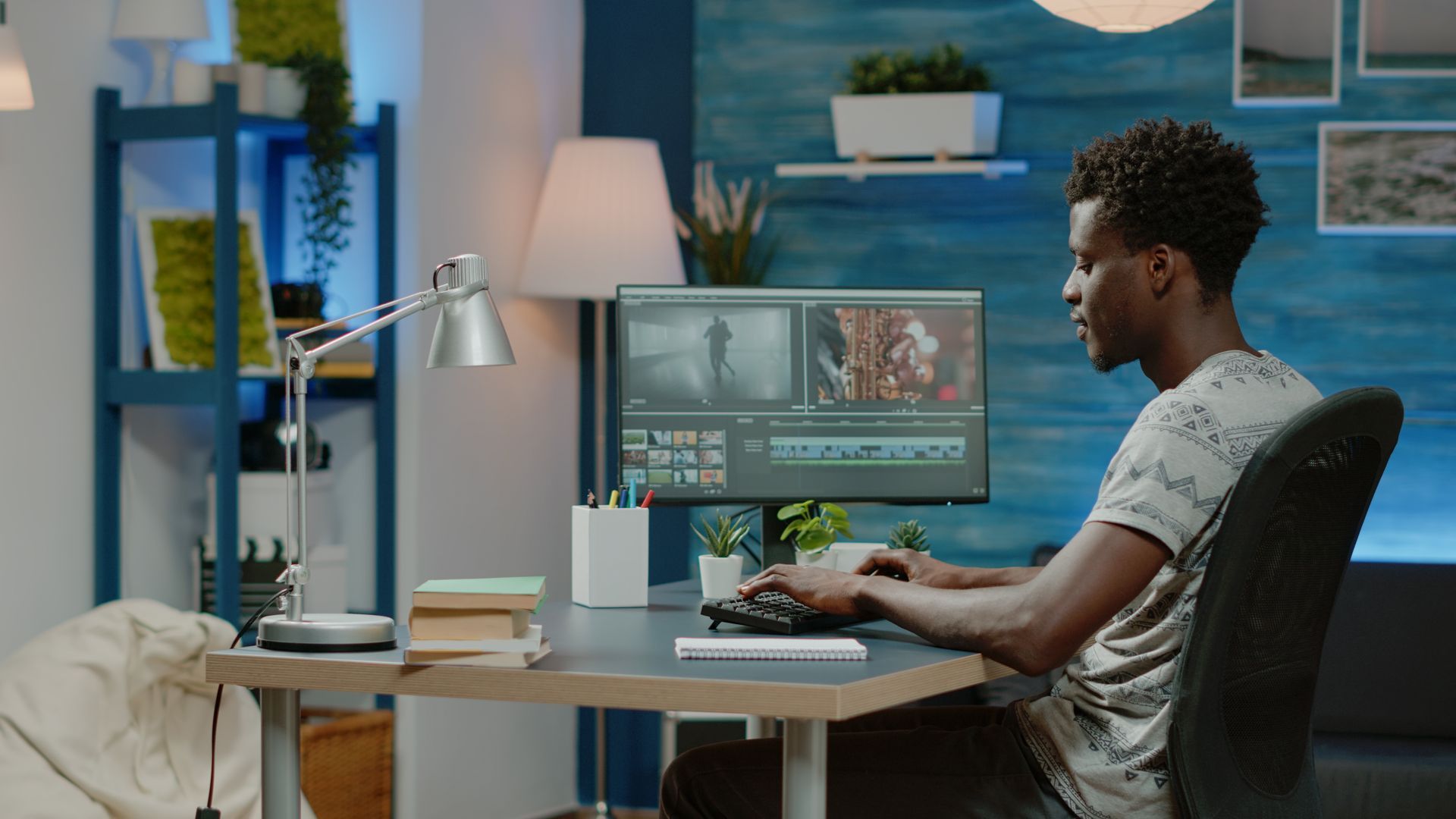 A man is sitting at a desk in front of a computer.
