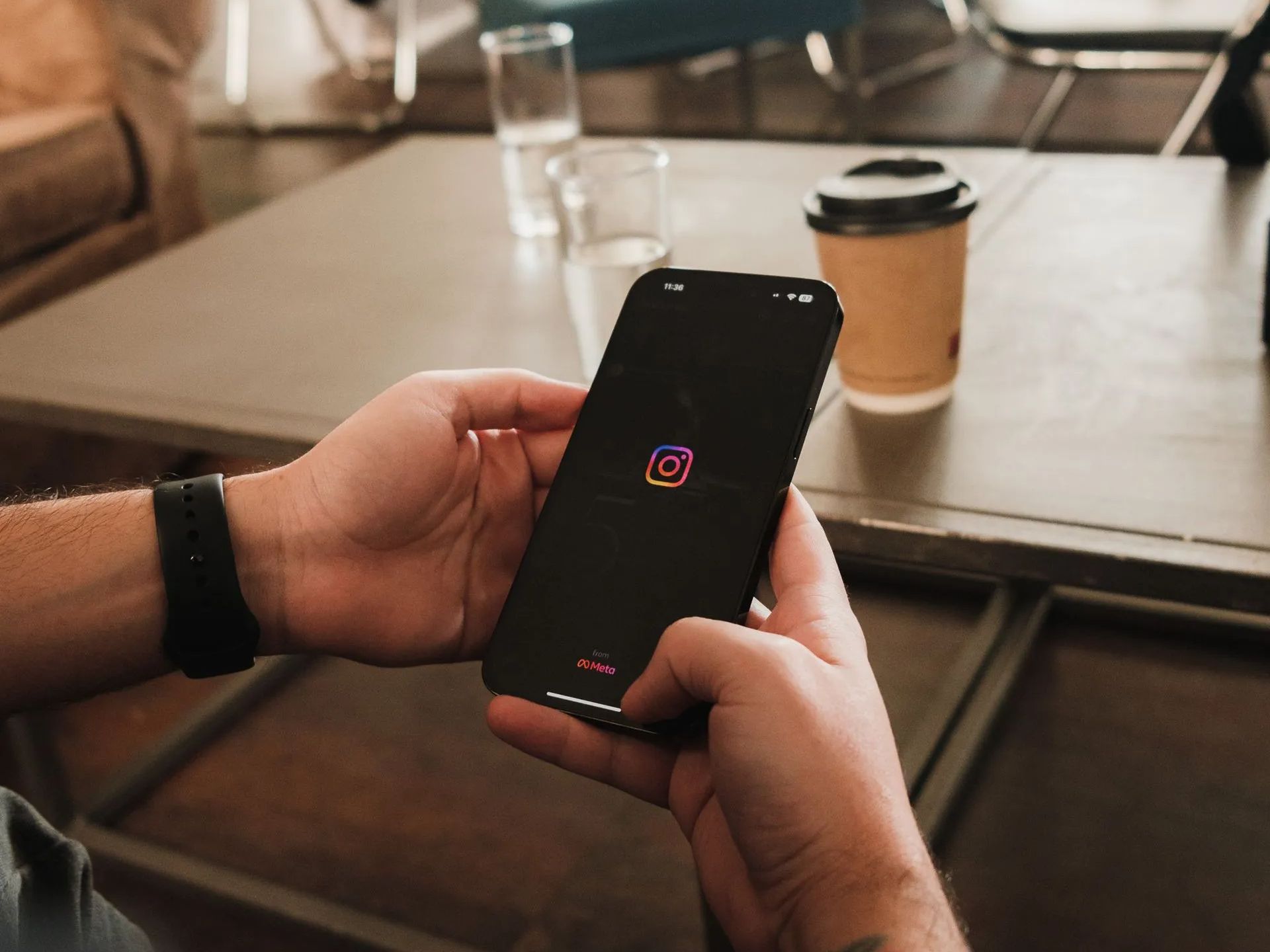 a person is holding a cell phone in their hands .