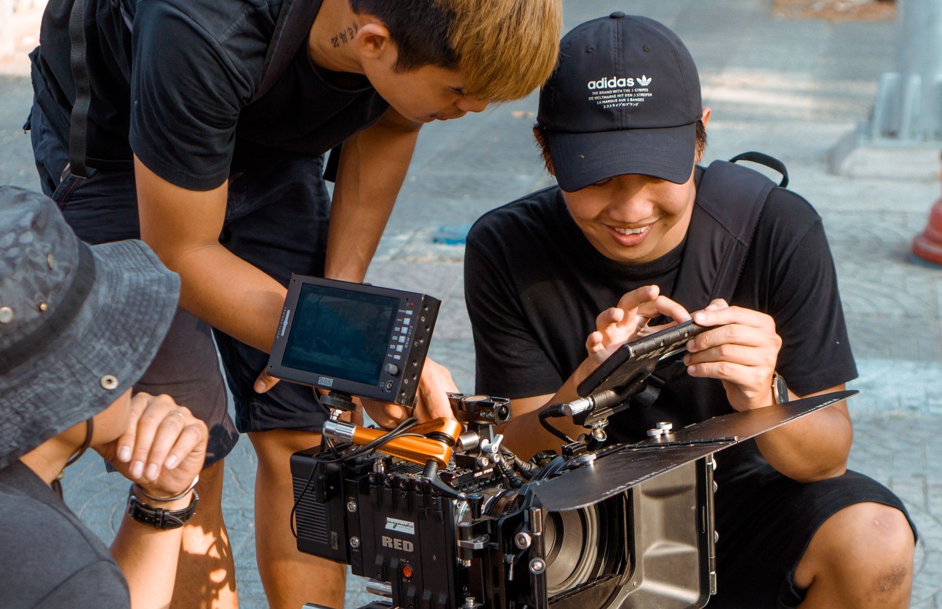 A group of young men are working on a camera.