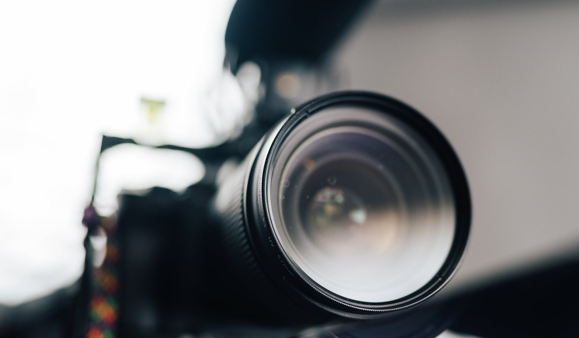 A close up of a camera lens on a table.