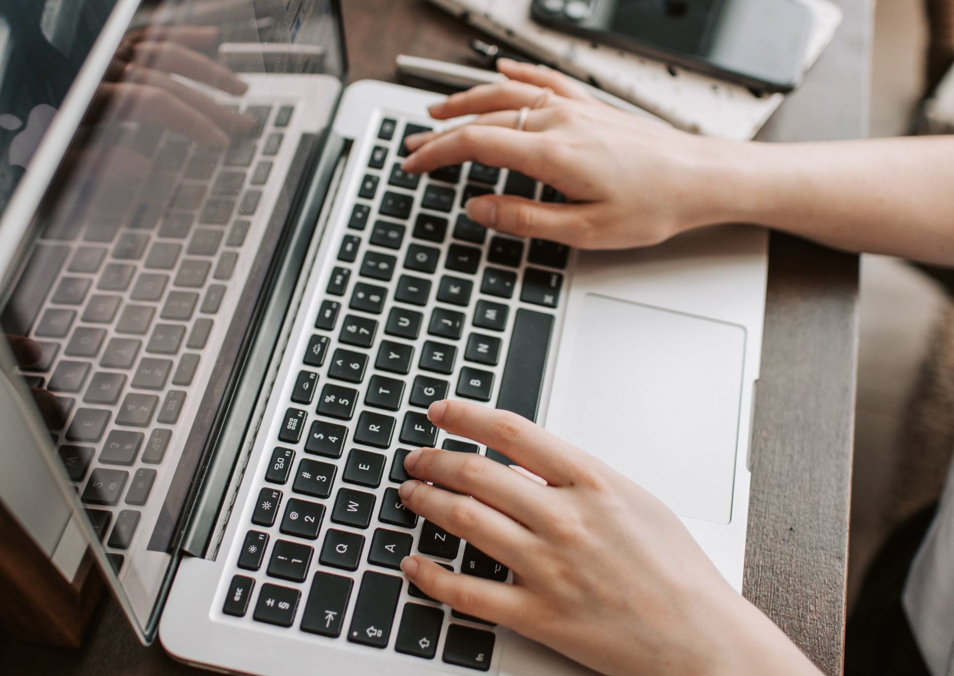 A person is typing on a laptop computer.