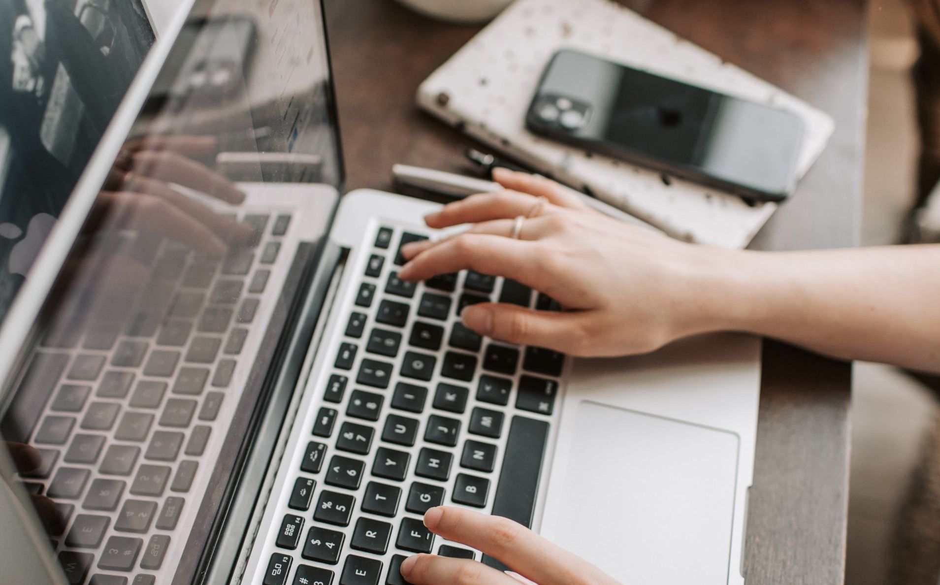 A person is typing on a laptop computer.
