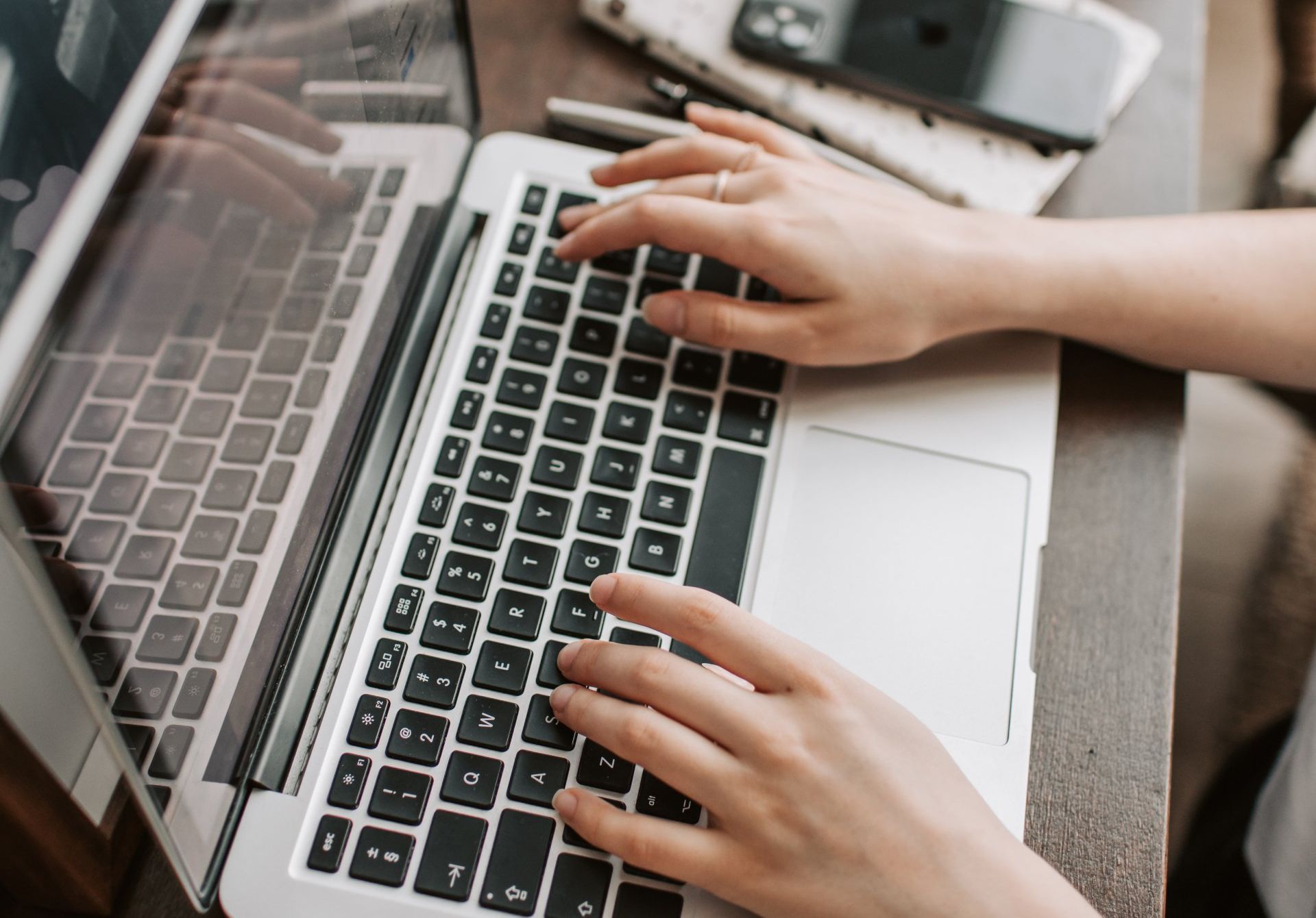 A person is typing on a laptop computer.