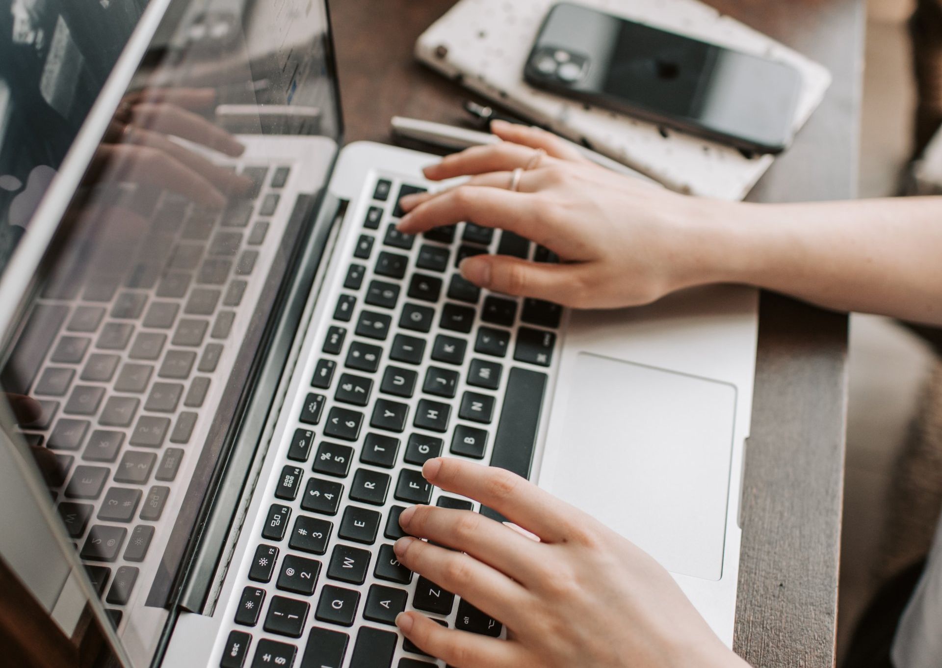 A person is typing on a laptop computer.