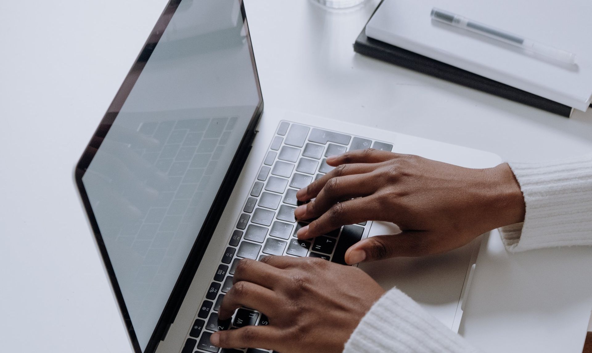 A person is typing on a laptop computer.