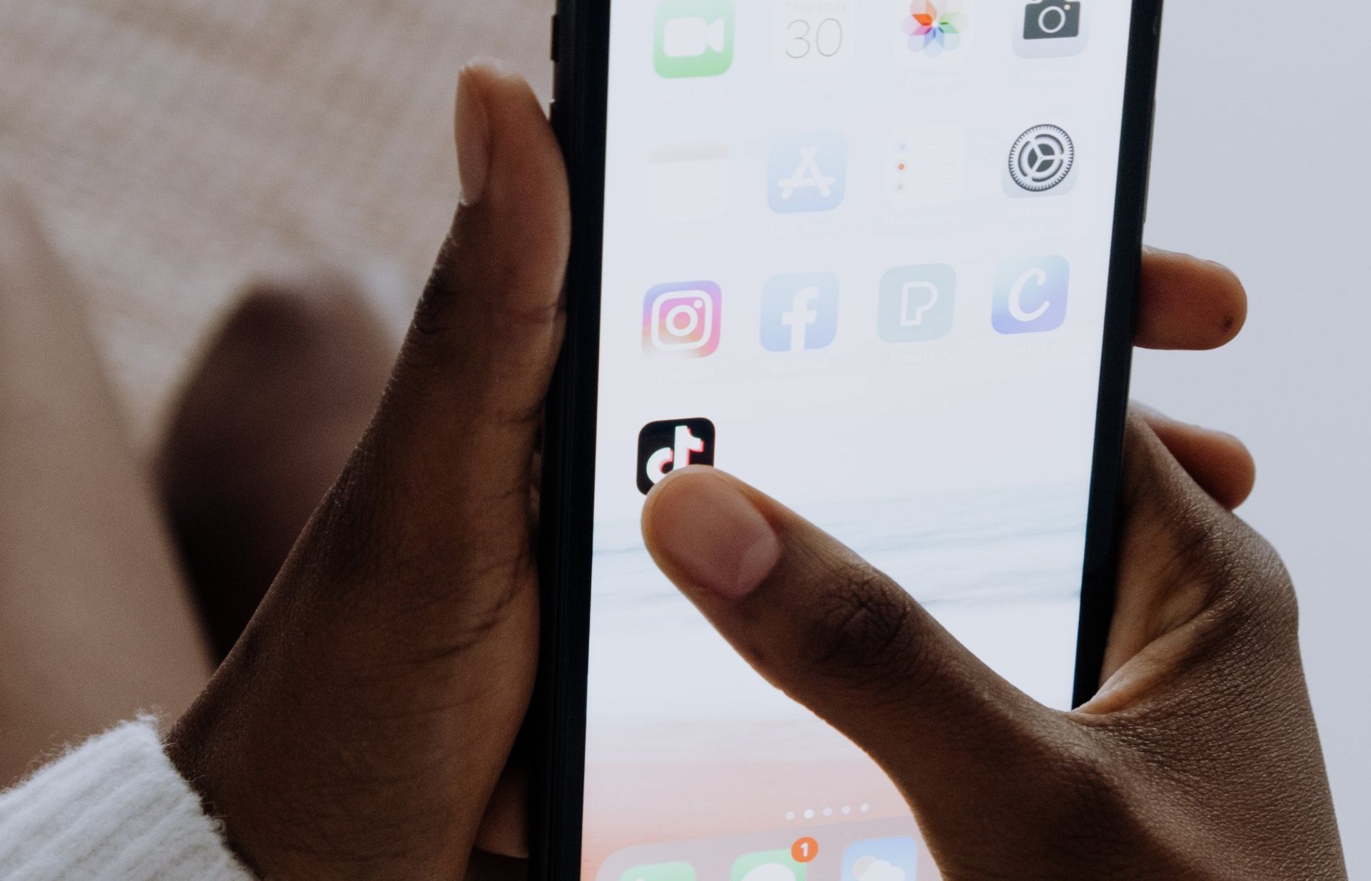 A person is holding a cell phone in their hand.